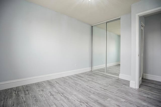 Basement bedroom renovation with mirrored closets in Brampton