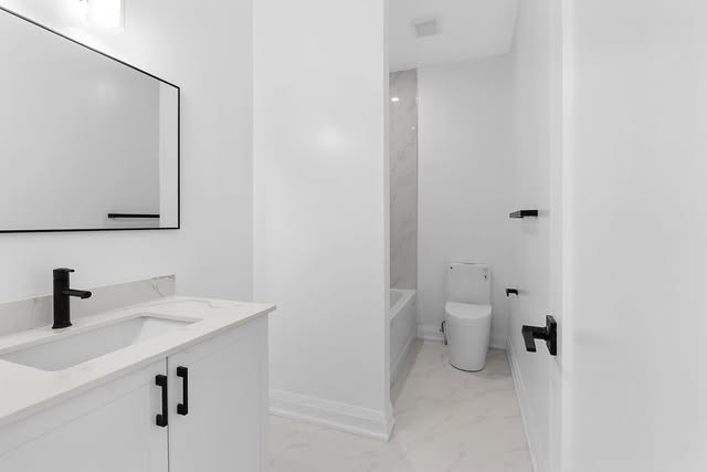 Bathroom renovation with modern vanity and black hardware in Mississauga