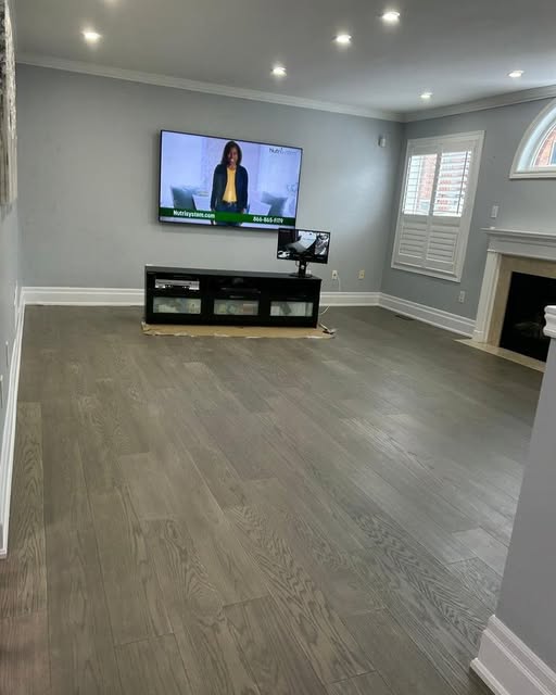 Family room renovation with fireplace and custom window shutters in Caledon